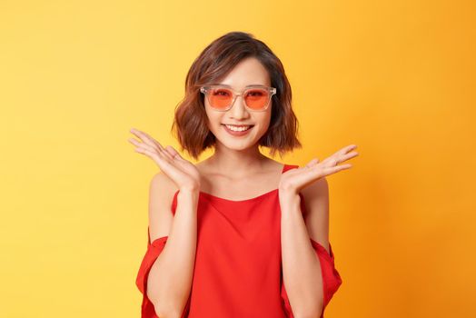 Studio portrait of surprised positive girl with short haircut dancing with smile.