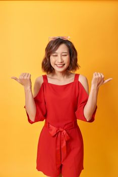 Emotional positive girl posing on yellow background. Good-looking young lady expressing cheerful emotions.