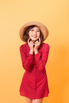Asian girl feeling excited and surprised isolated on orange background. 