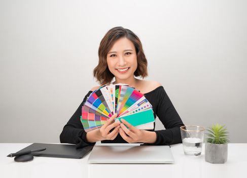 Portrait of pretty female designer working with colors 