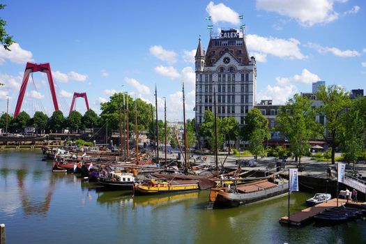 ROTTERDAM, NETHERLANDS - JUNE 9, 2022: Oude Haven, one of the oldest ports of Rotterdam with Witte Huis building and Willemsbrug bridge, Netherlands