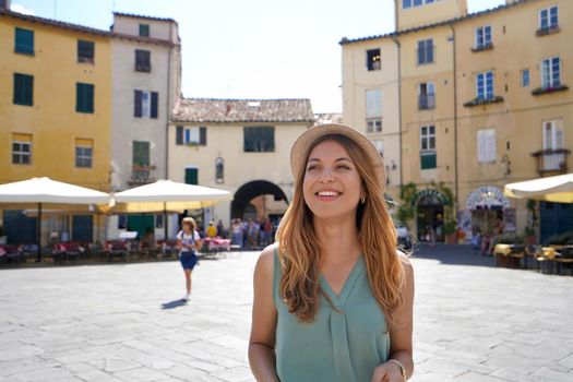 Discovering Italy. Cheerful young woman visiting the historic city of Lucca, Tuscany, Italy.