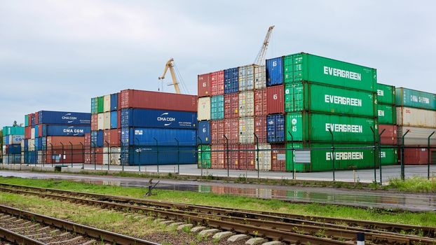 Odessa, Ukraine - May 19, 2021: Freight containers in the port terminal. Containers labeled Evergreen in the foreground.