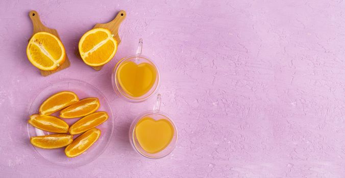 Orange juice orange on a pink background. Preparation of orange juice for health. Flat lay, copy space