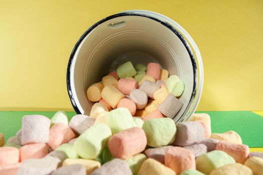 A lot of marshmallows close-up. Delicious dessert or addition to cocoa. Color background