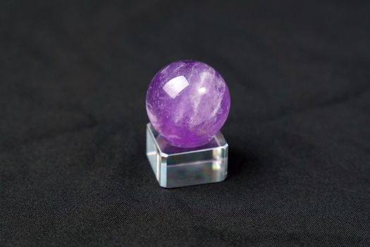Amethyst stone, purple colored crystal stone for jewelry making. Black background. Selective focus