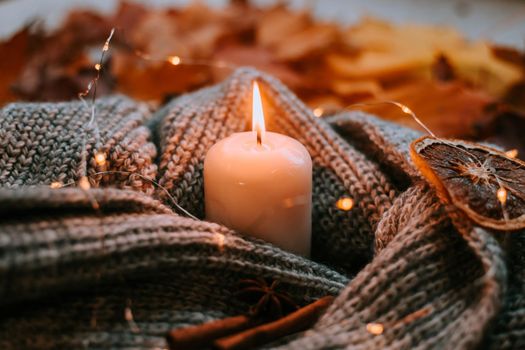 Autumn leaves and candles . cozy vibes. Autumn article.