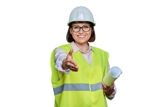 Female industrial worker in hardhat vest extending hand for handshake