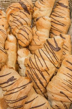 Fresh croissants with chocolate filling background baking bakery counter