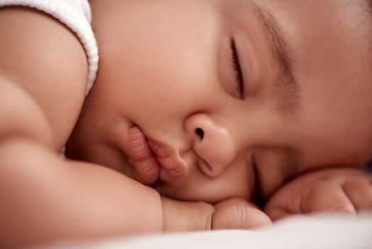 The world stops for a sleeping baby. an adorable baby boy sleeping peacefully on the bed at home.