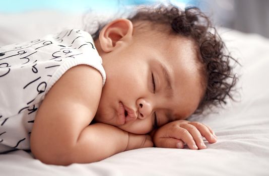 Sweet dreams, sweet one. an adorable baby boy sleeping peacefully on the bed at home.