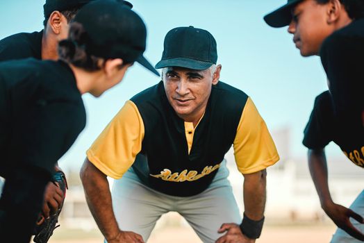 Keep doing what you are doing. a baseball coach talking to his team while out on the pitch.