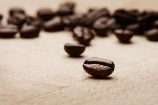 Coffee brings out the best in us. Still life shot of coffee beans on a wooden countertop.