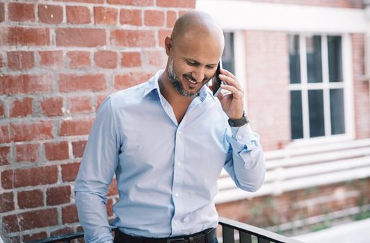 In business, connectivity is king. a mature businessman using a smartphone outside of a modern office.