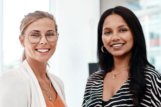 Two of the best. Cropped portrait of two attractive young businesswomen standing in their office.