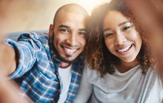 Smiling couple taking selfies as home owners, bonding together or enjoying new real estate purchase. Portrait of a happy man and woman celebrating and capturing memory picture as home investors