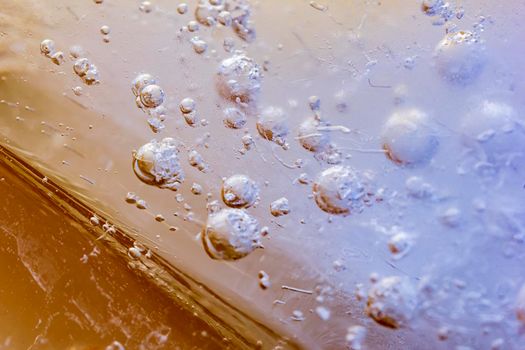 Macro shot of frozen bubbles in ice