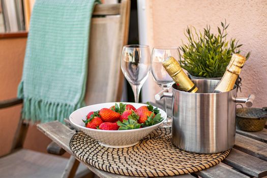 Romantic still life with champagne and strawberry on a terrace.
