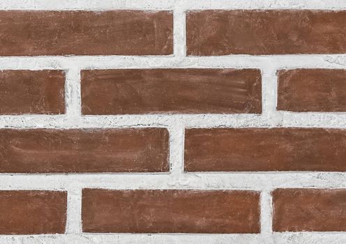 Old brown brick wall with white cement texture background, close-up