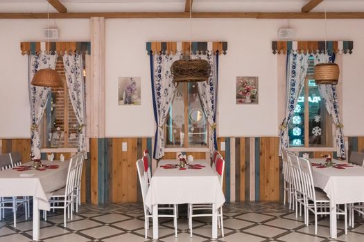 Belarus, Minsk region - January 5, 2020: Cozy traditional restaurant interior in rural country design style