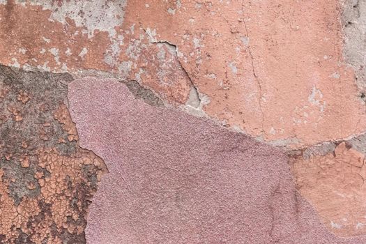 Crumbling peeling plaster with old colored wall surface texture rough background