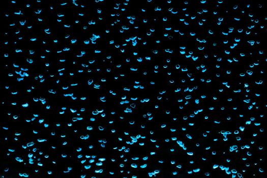Movement of abstract blue water bubbles up, dynamics, liquid on a black background