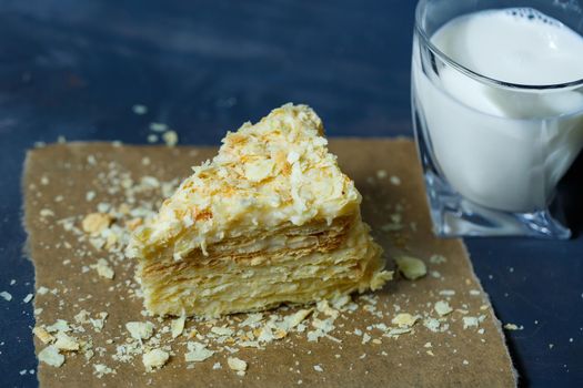 homemade Napoleon cake with cream on a gray background.
