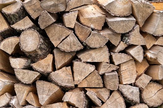 chopped firewood background. texture of firewood stacked in a woodpile