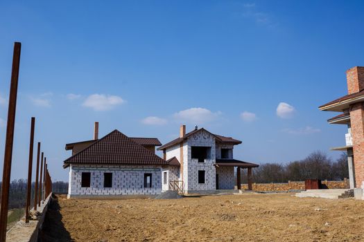 construction of a country two-story house from a gas block