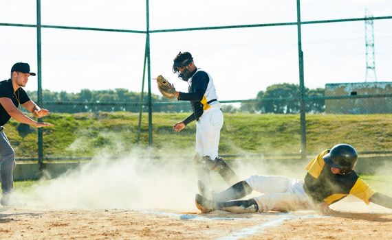The dust is his playground. Full length shot of a young baseball player reaching base during a game on the field.