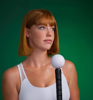 Hockey comes before everything else. an attractive young sportswoman standing and posing with hockey equipment against a green studio background.