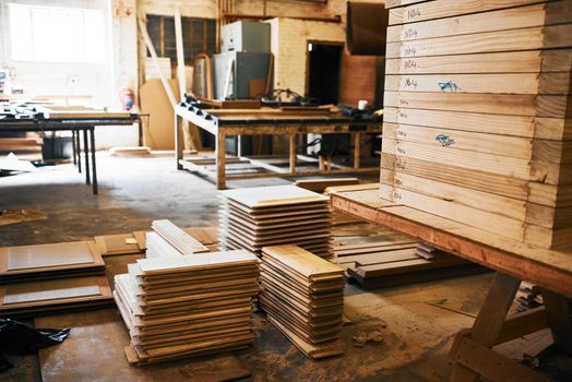 Were stocked up on the finest wood in the industry. Still life shot of piles of wood stacked inside a carpentry workshop.