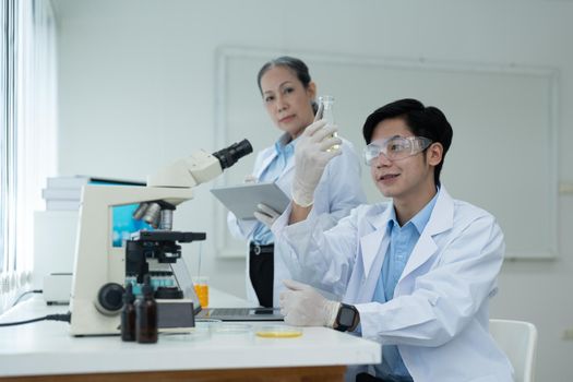 Science Oil Chemistry Expertise is Experiment Analysis With Microscope Equipment in Laboratory. Double Exposure of Scientist Chemical Research Testing and Study Oil Lubricant in Lab. Oil Industry.