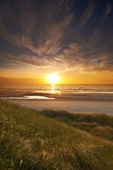 Sunset by the beach. A photo of sunset at the coastline of Jutland, Denmark.