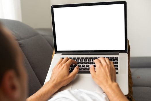 Cropped image of a young man working on his laptop, rear view of business man hands busy using laptop, typing on computer