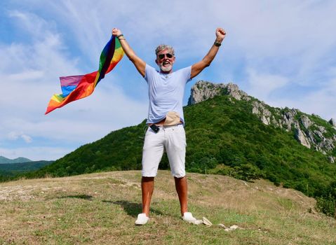 Senior man Gay gray-haired holds LGBT flag