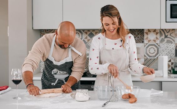Lots of fun is on the menu. a happy mature couple baking together at home.