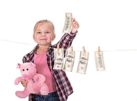 children and money. Girl with a piggy bank. Girl hanging dollar bills on a rope isolated on white background