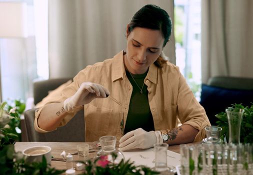 Hydroponic grown plants have higher bacteria and pest resistance. an attractive young botanist adding a liquid nutrient to a water based plant inside a test tube.