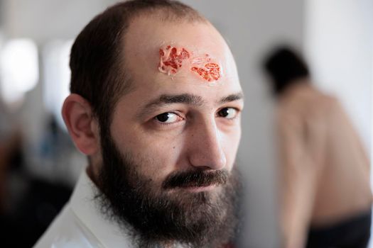 Portrait of man with bloody zombie wound
