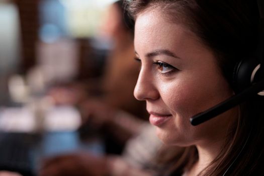 Telecommunication receptionist answering client call on headset