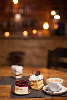 Assorted cakes for dessert over a wooden table in a coffee shop