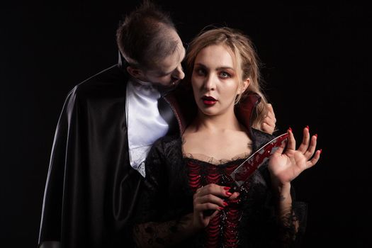 Portrait of a beautiful couple in medieval costumes with vampire style make-up for halloween