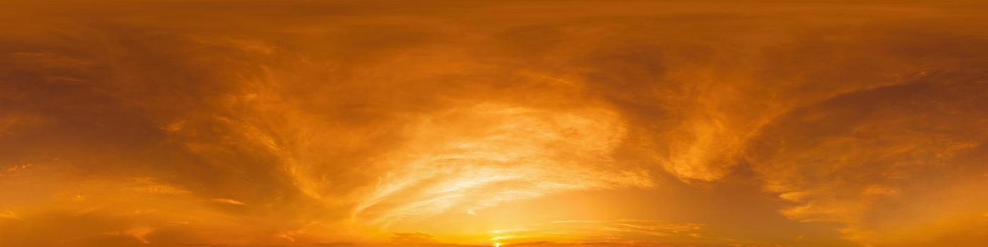 Golden glowing sunset sky panorama with Cirrus clouds. Hdr seamless spherical equirectangular 360 panorama. Sky dome or zenith for 3D visualization and sky replacement for aerial drone 360 panoramas.