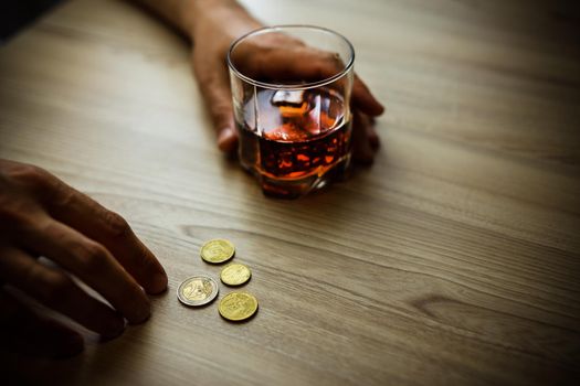 Fired man countsing his last money to drink expensive alcohol.