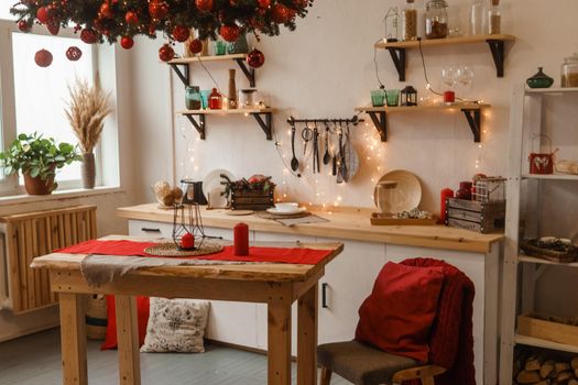 The kitchen is decorated in a Christmas style with red accents. Cozy atmosphere of winter holidays