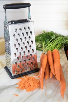 Cheese Grater and Shredded Carrots