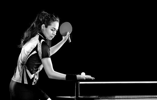 Young pretty sporty girl playing table tennis