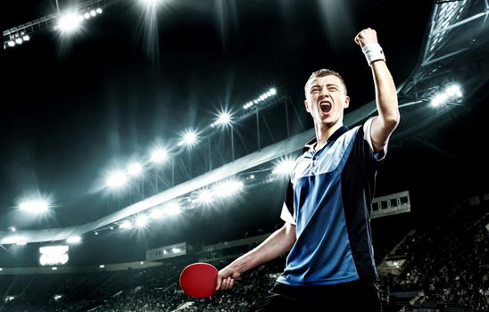 Young handsome sportsman celebrating flawless victory in table tennis