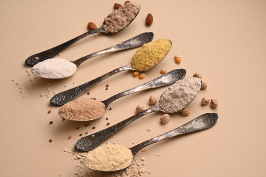 Gluten free text and spoons of various gluten free flour. Flat lay, top.